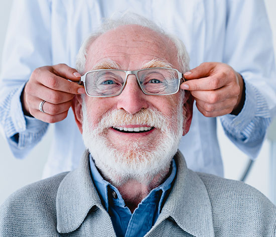 Memphis man tries on new glasses at eye doctor near Georgetown TN